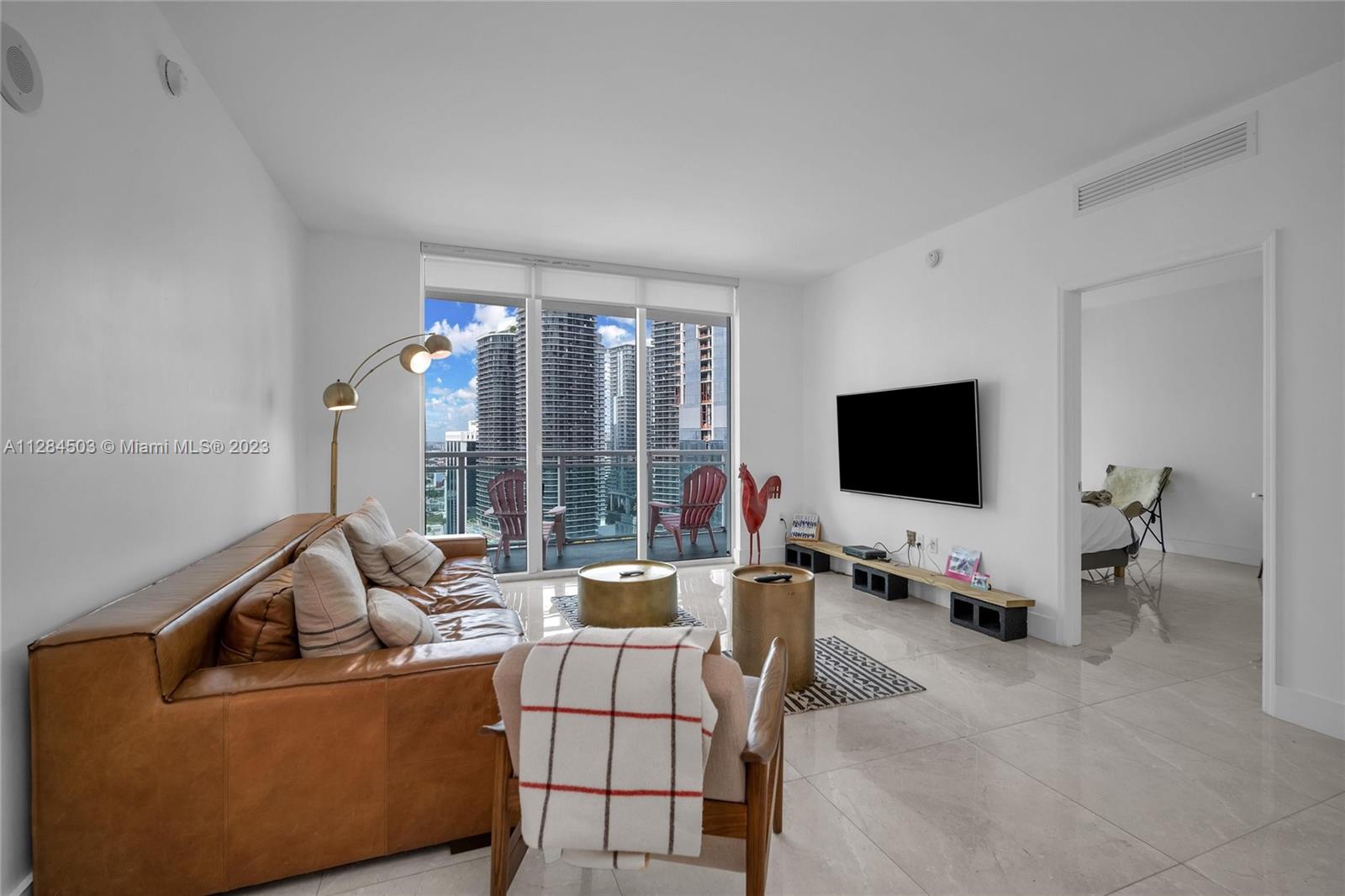 Brickell Miami, FL 33131 - Photo 5 of 29 a living room with furniture and a flat screen tv