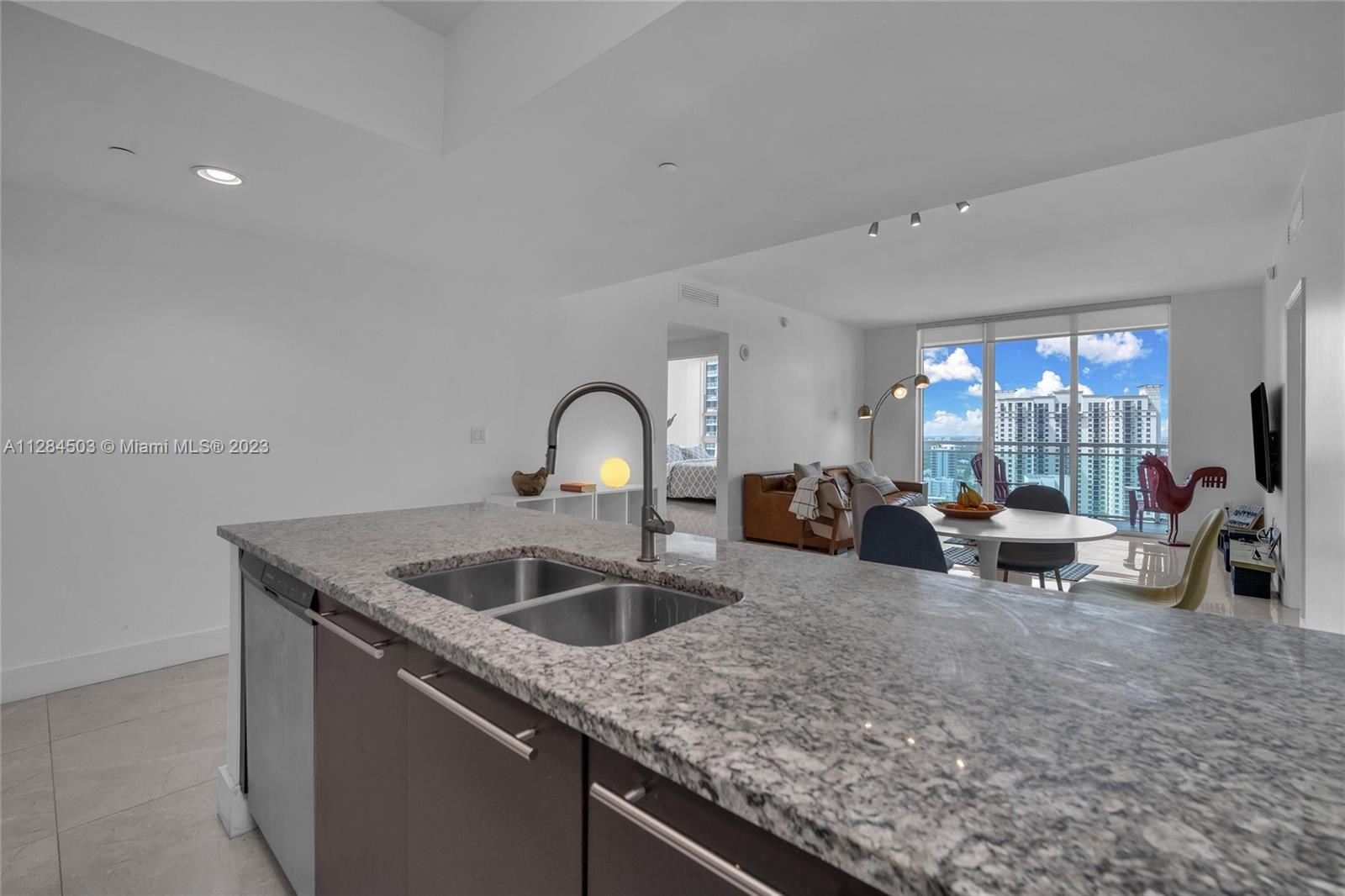 Brickell Miami, FL 33131 - Photo 7 of 29 a kitchen with sink a counter top space and living room view