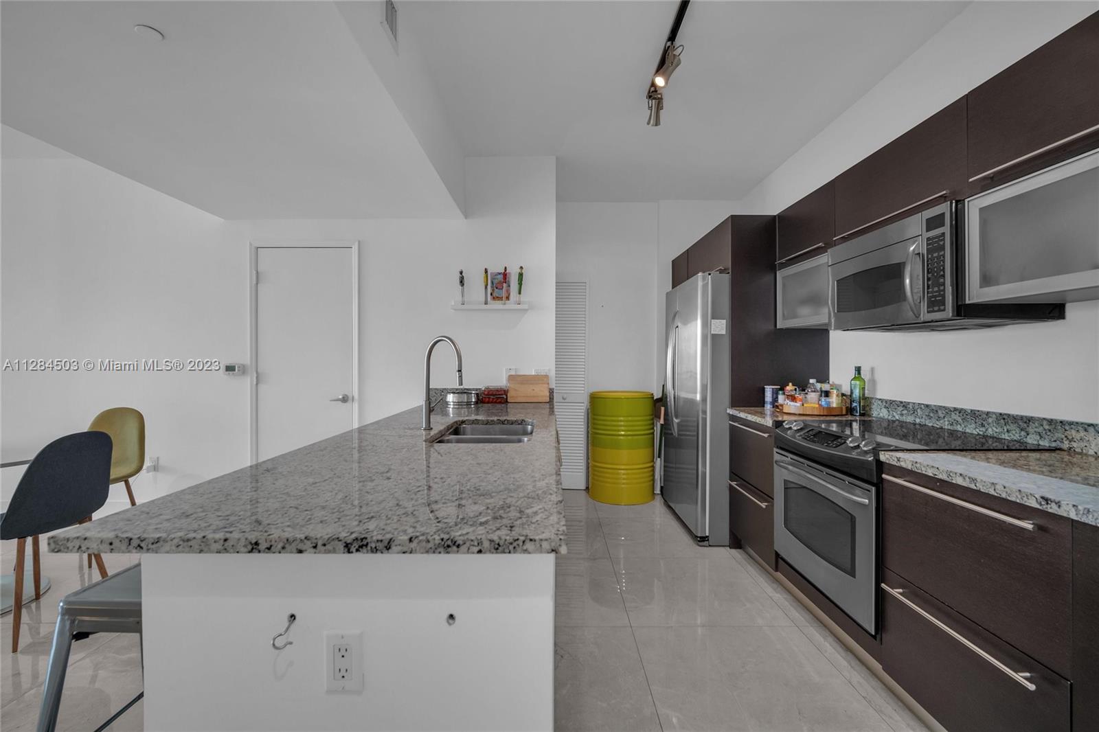 Brickell Miami, FL 33131 - Photo 8 of 29 a kitchen with sink cabinets and appliances
