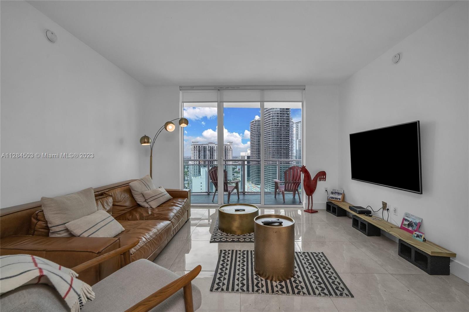 Brickell Miami, FL 33131 - Photo 9 of 29 a living room with furniture and a flat screen tv