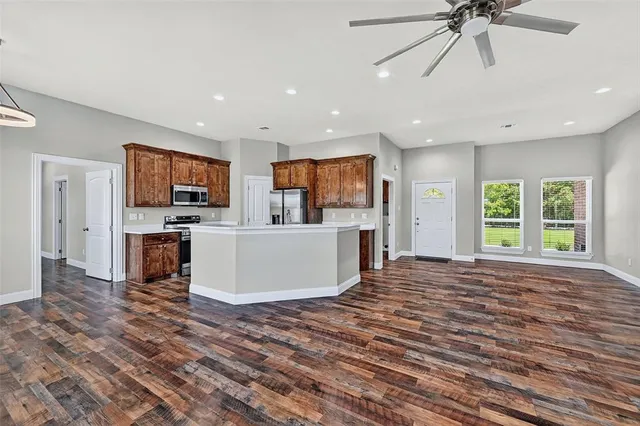 a view of kitchen with microwave a stove and furniture
