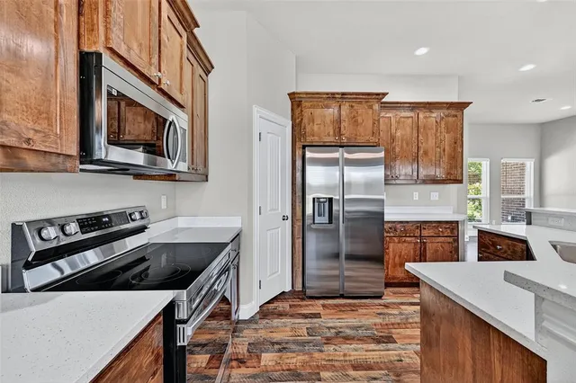 a kitchen that has a microwave a stove and a refrigerator