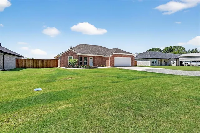a view of a house with a yard and sitting area