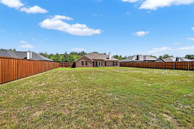 a view of a field with sitting area