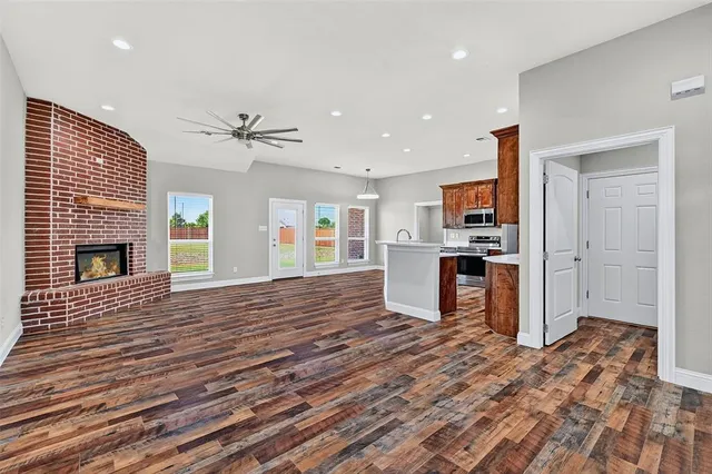 a view of kitchen with sink microwave and refrigerator
