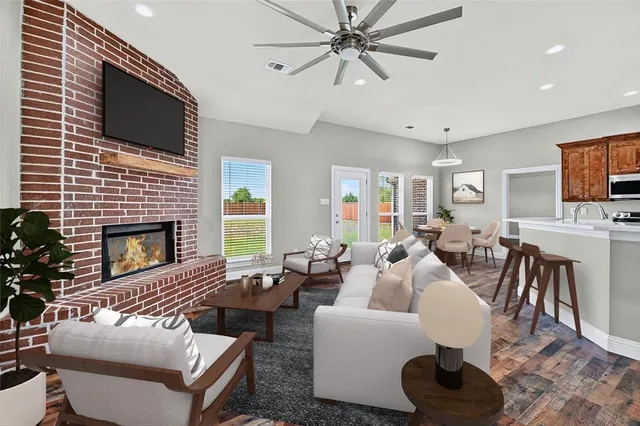 a living room with furniture a flat screen tv and a fireplace