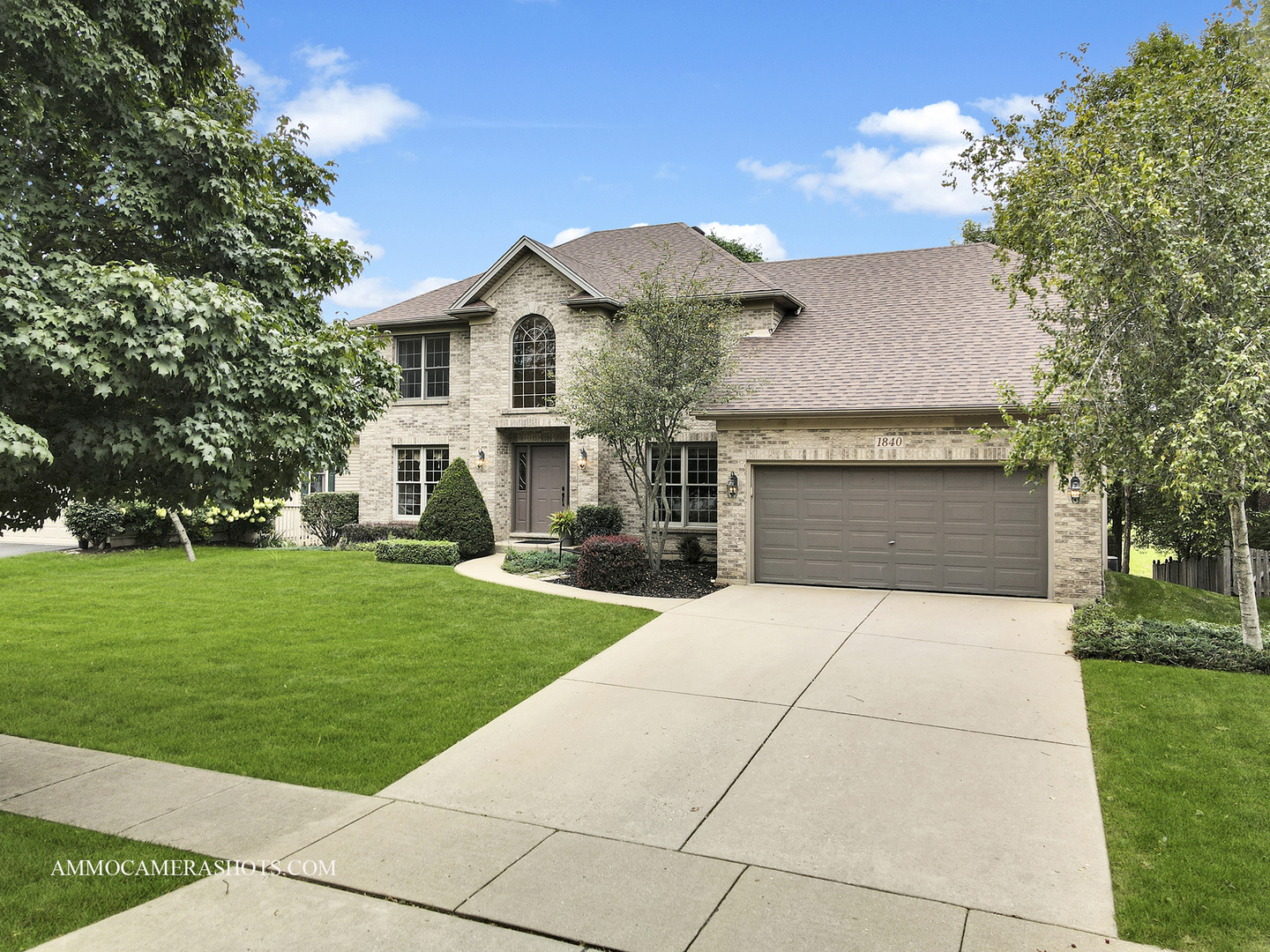 1840 Marne Road Bolingbrook, IL 60490 - Photo 2 of 37 a front view of a house with a garden and trees