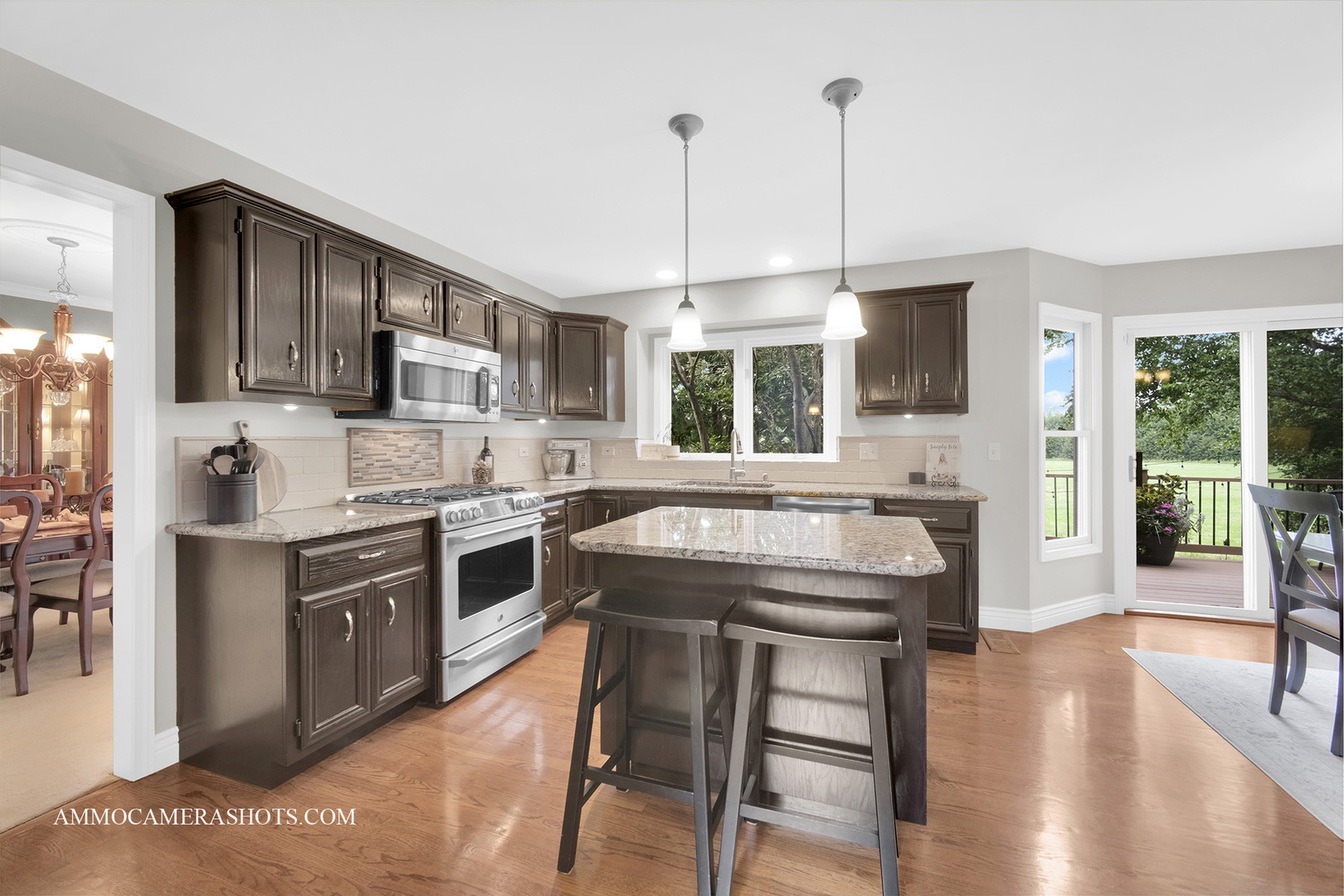 1840 Marne Road Bolingbrook, IL 60490 - Photo 9 of 37 a kitchen with a stove a sink dishwasher a refrigerator and a dining table with wooden floor