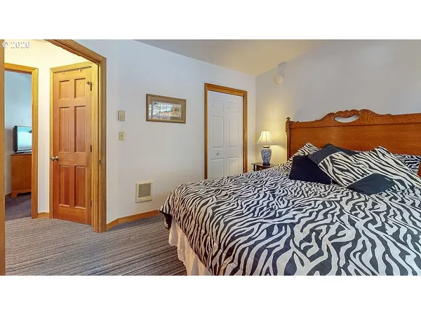 a bedroom with a bed and a painting