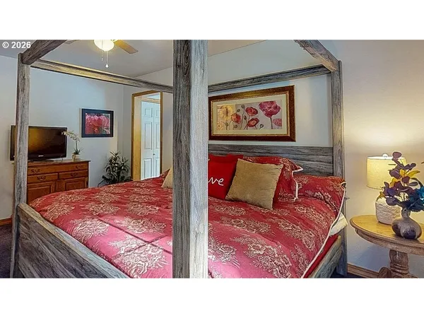 a bed room with a bed and a television