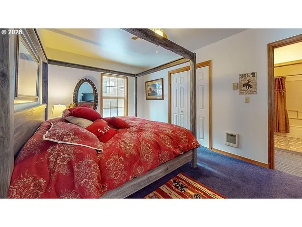 a living room with a bed furniture and a window