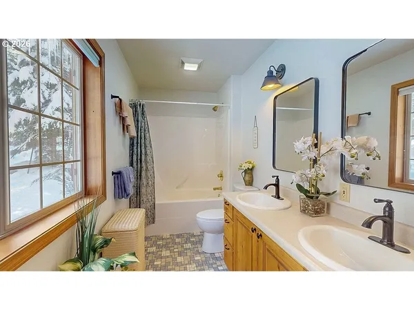 a bathroom with a sink mirror vanity and toilet