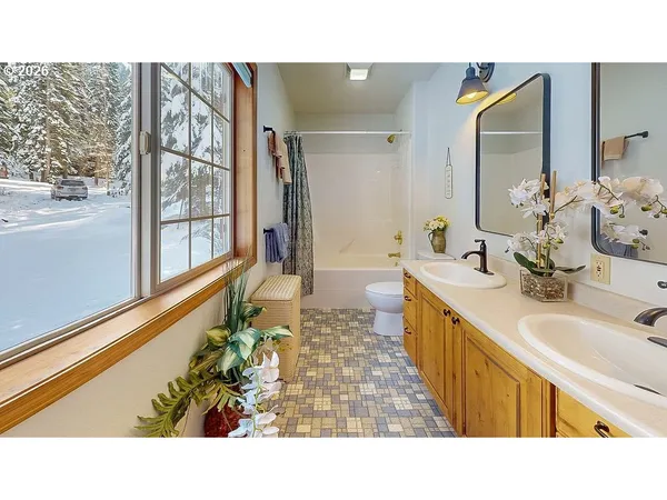 a bathroom with a sink mirror and a bathtub