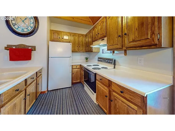 a kitchen with stainless steel appliances granite countertop a sink and cabinets