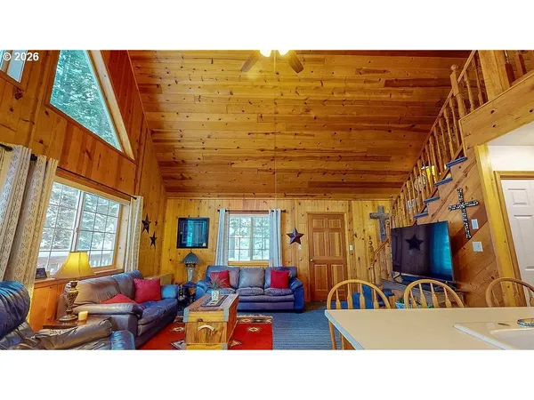 a outdoor living space with furniture and a flat screen tv