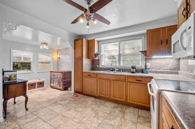 a kitchen with granite countertop cabinets stainless steel appliances a sink and window