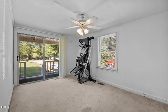 a front view of a house with swimming pool and yard
