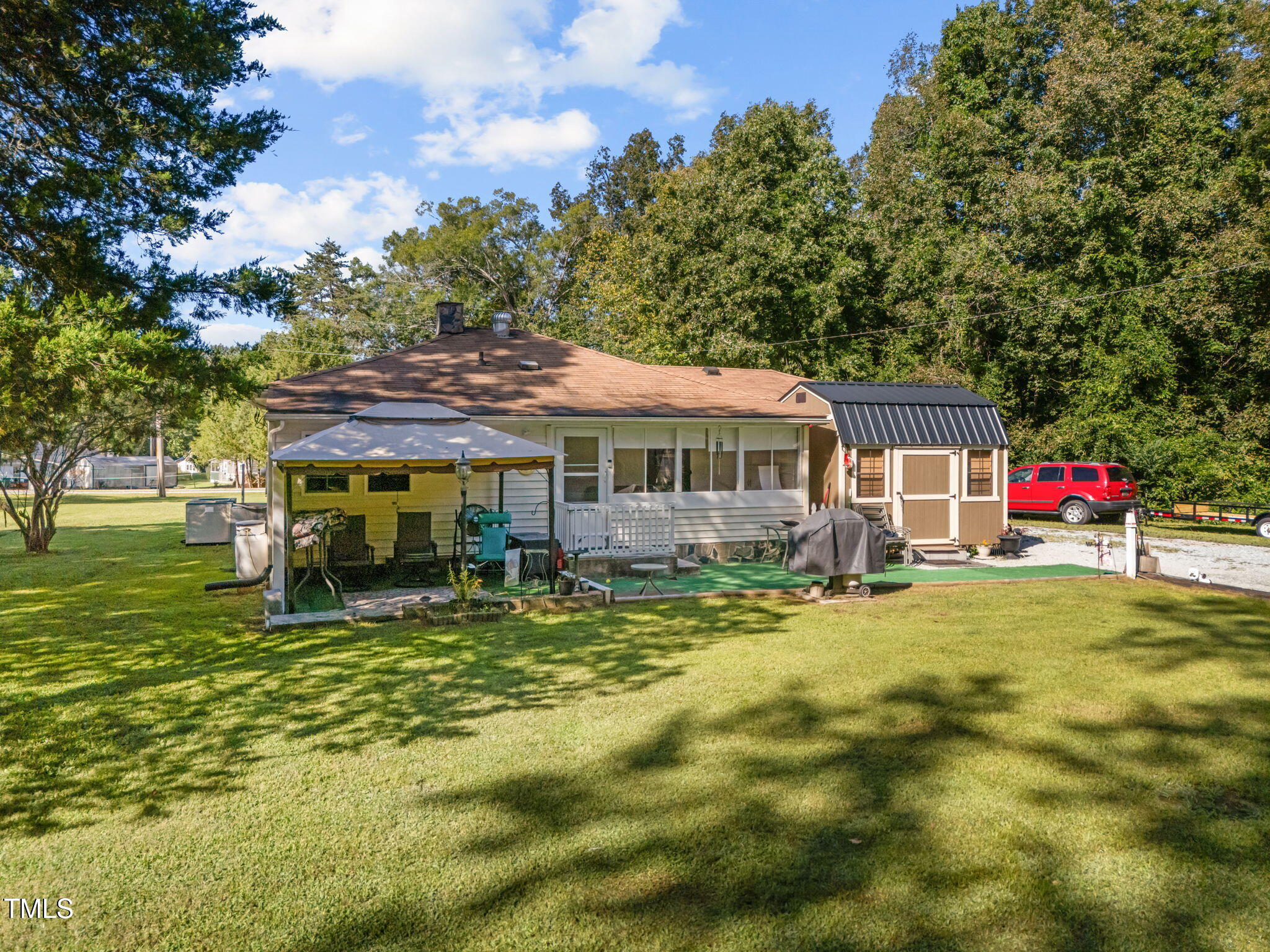 122 Old Surl Road Roxboro, NC 27574 - Photo 4 of 45 a backyard of a house with yard table and chairs