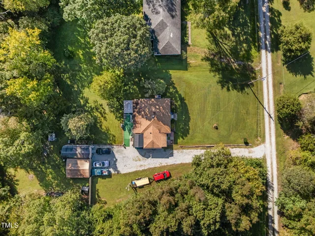 an aerial view of a house with a yard basket ball court and outdoor seating