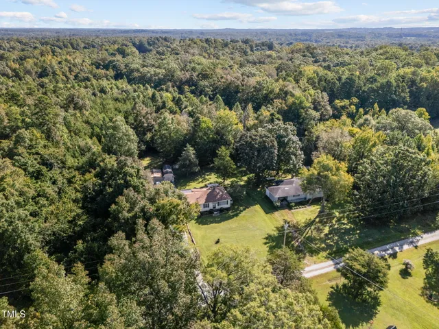 a aerial view of a house with swimming pool and big yard