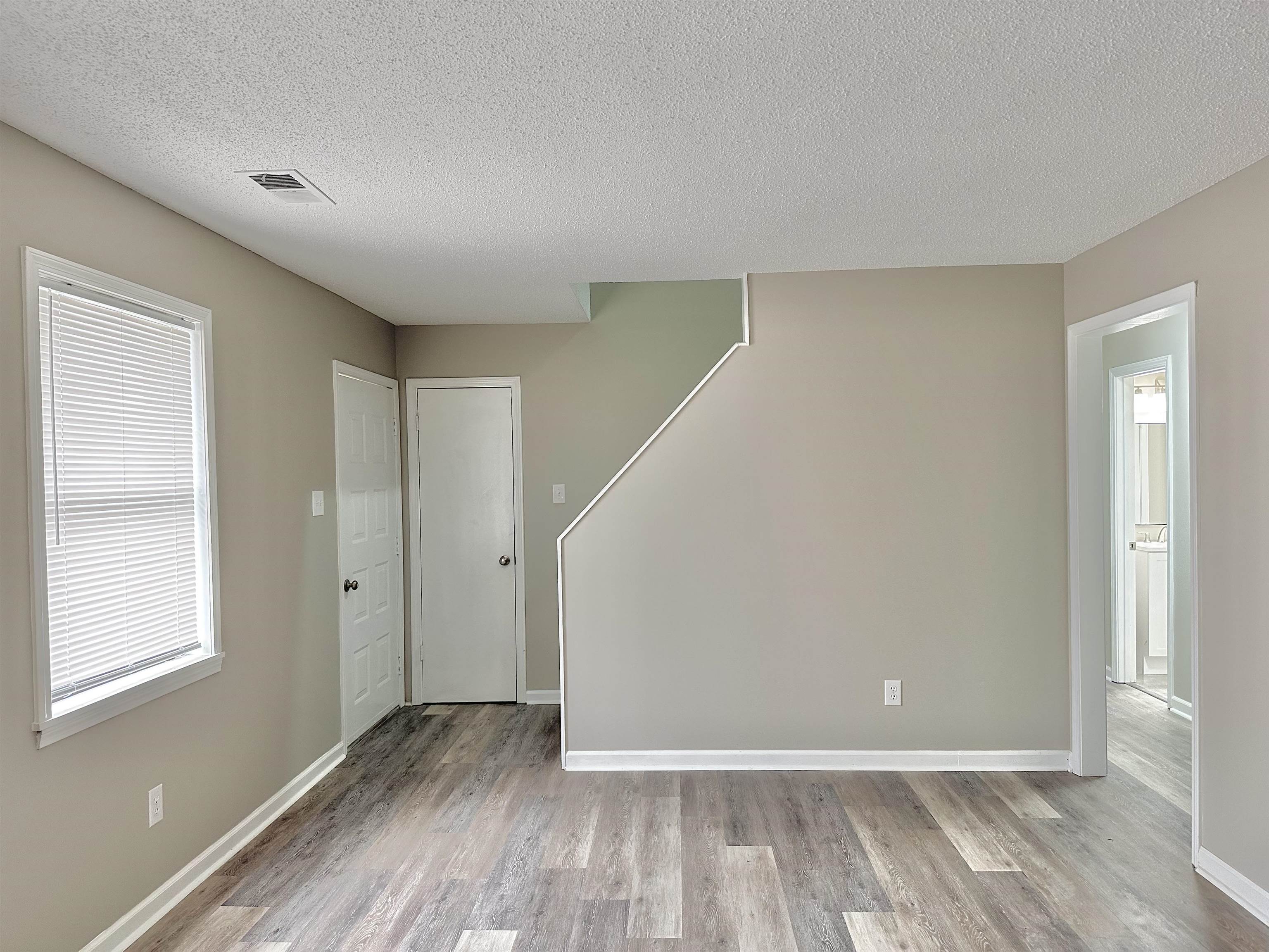 4376 Coleman Road Memphis, TN 38128 - Photo 15 of 21 a view of an empty room with wooden floor and a window