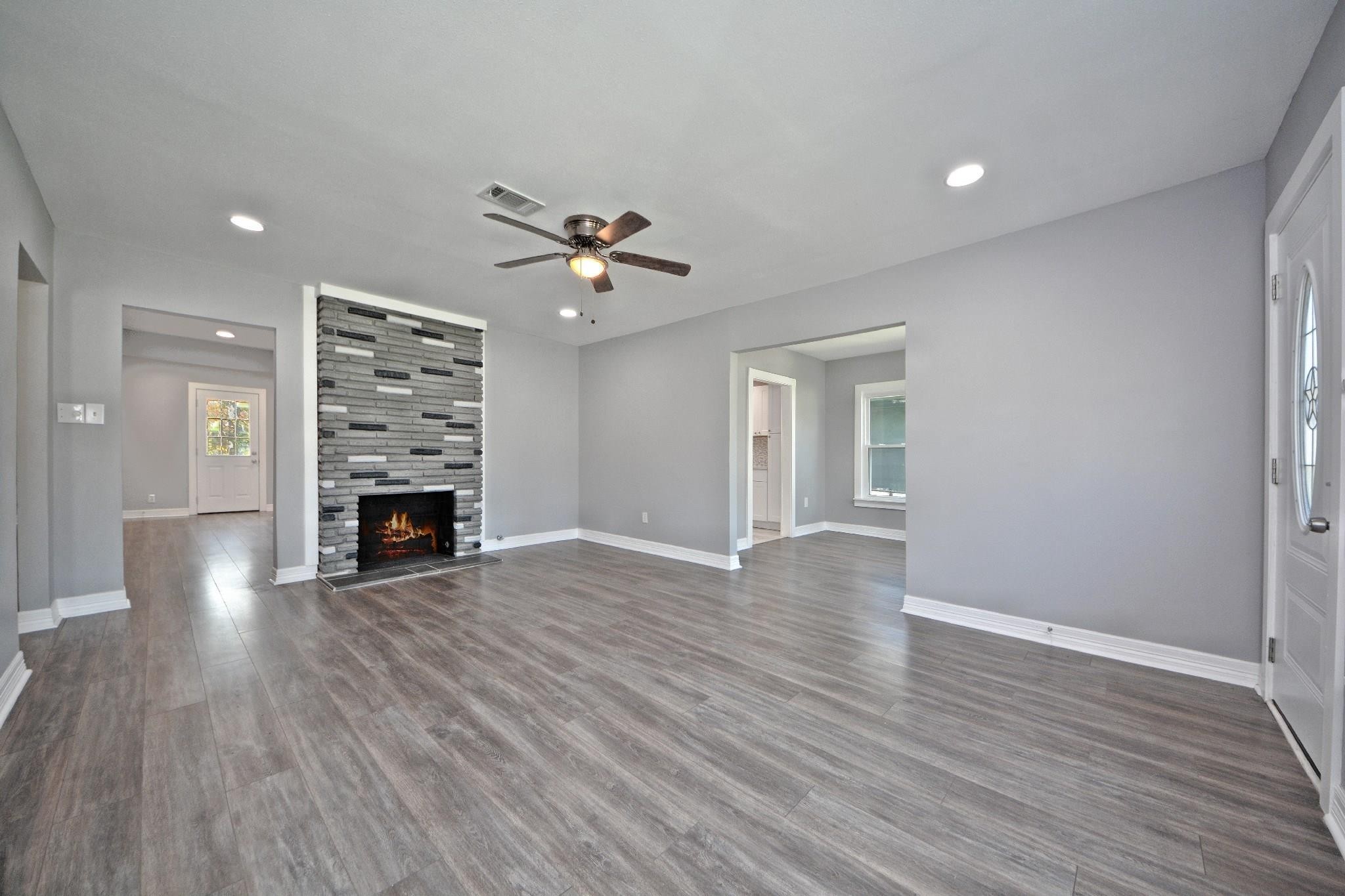 3834 Rosedale Street Houston, TX 77004 - Photo 20 of 48 a view of empty room with wooden floor and fireplace