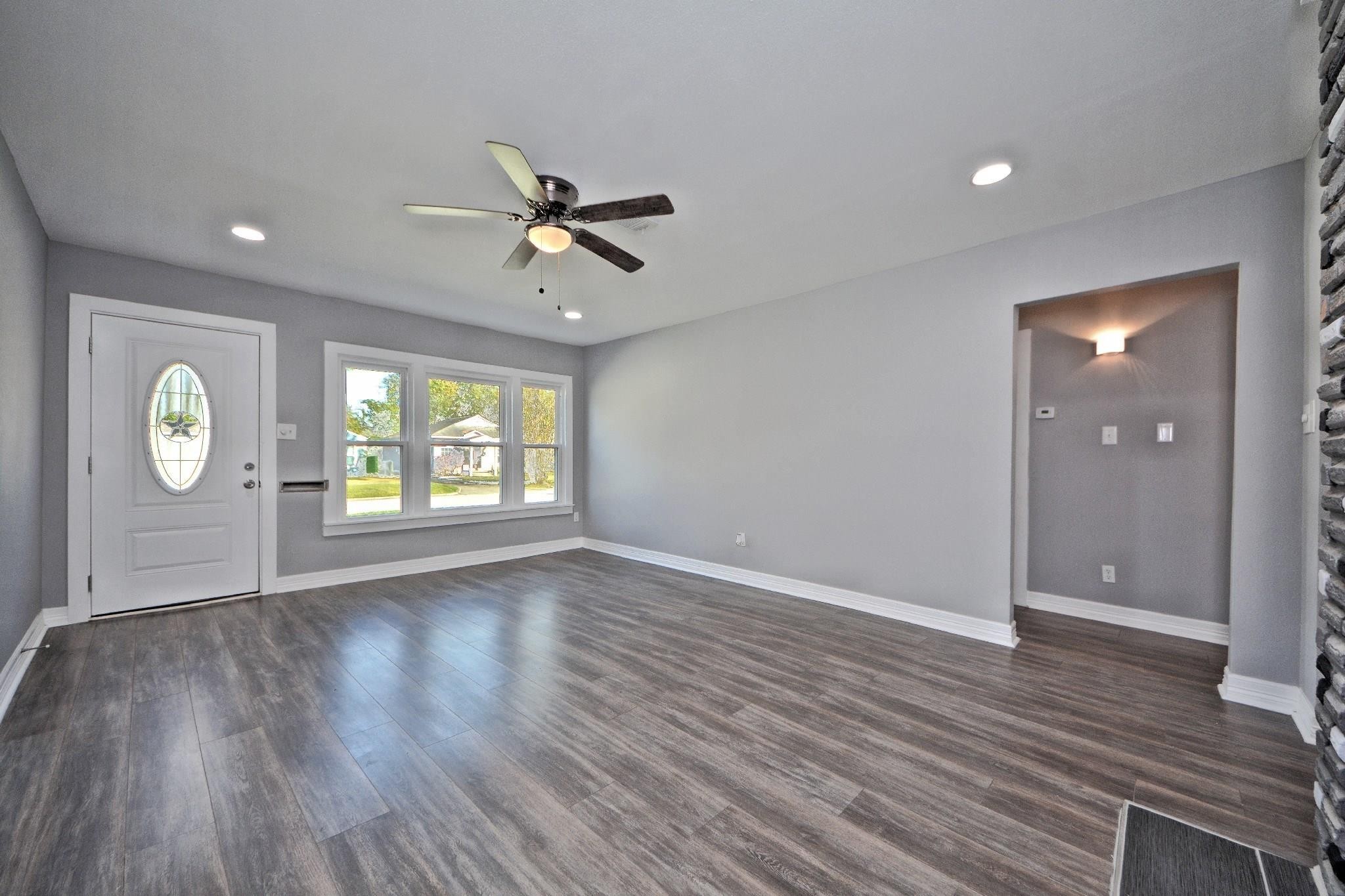 3834 Rosedale Street Houston, TX 77004 - Photo 22 of 48 a view of an empty room with window and wooden floor