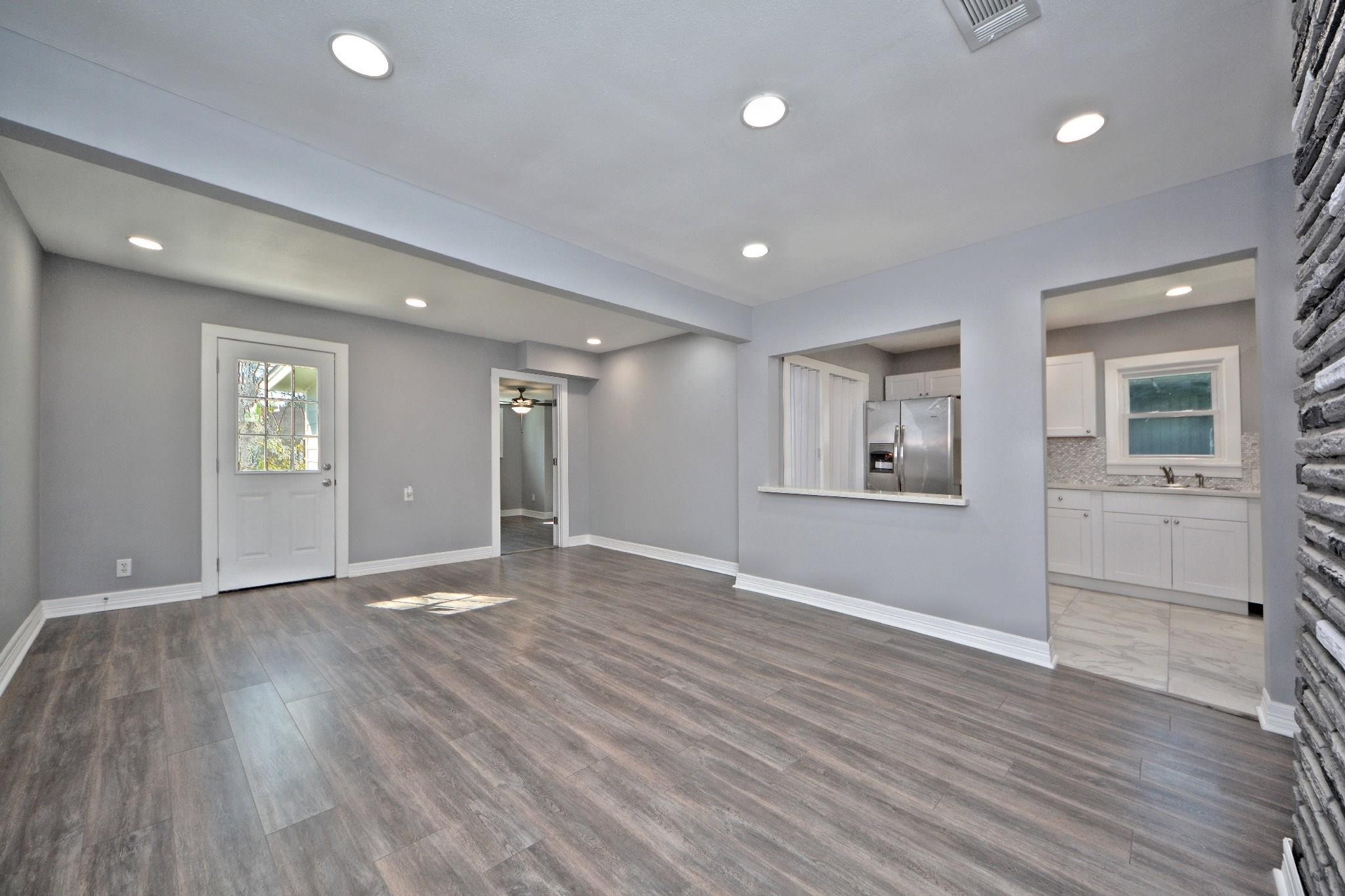 3834 Rosedale Street Houston, TX 77004 - Photo 29 of 48 a view of an empty room with wooden floor and a window
