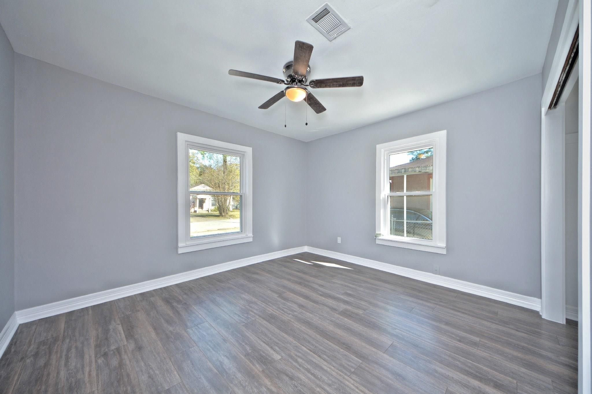 3834 Rosedale Street Houston, TX 77004 - Photo 38 of 48 a view of an empty room with wooden floor and a window