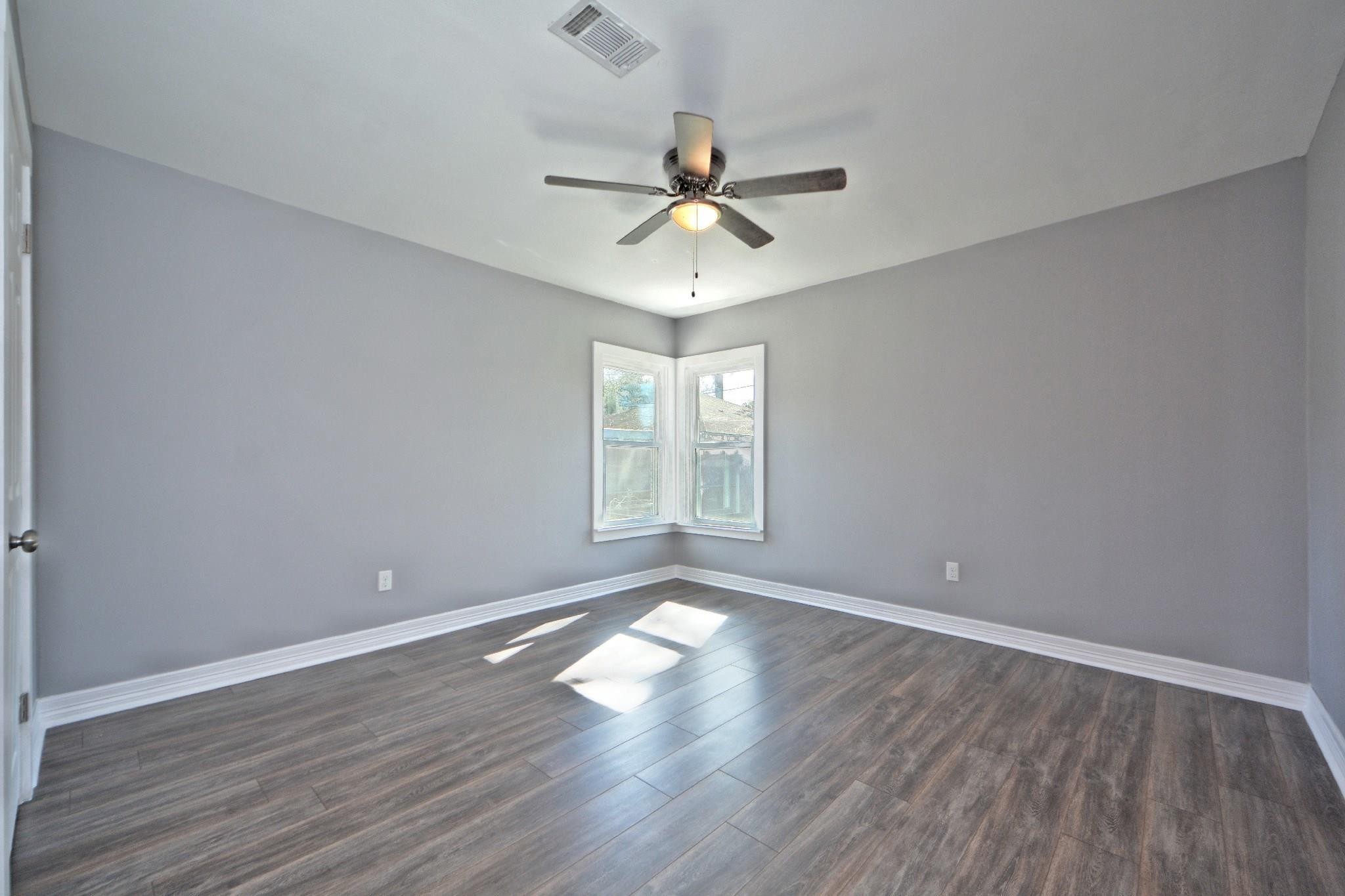 3834 Rosedale Street Houston, TX 77004 - Photo 44 of 48 wooden floor in an empty room with a window