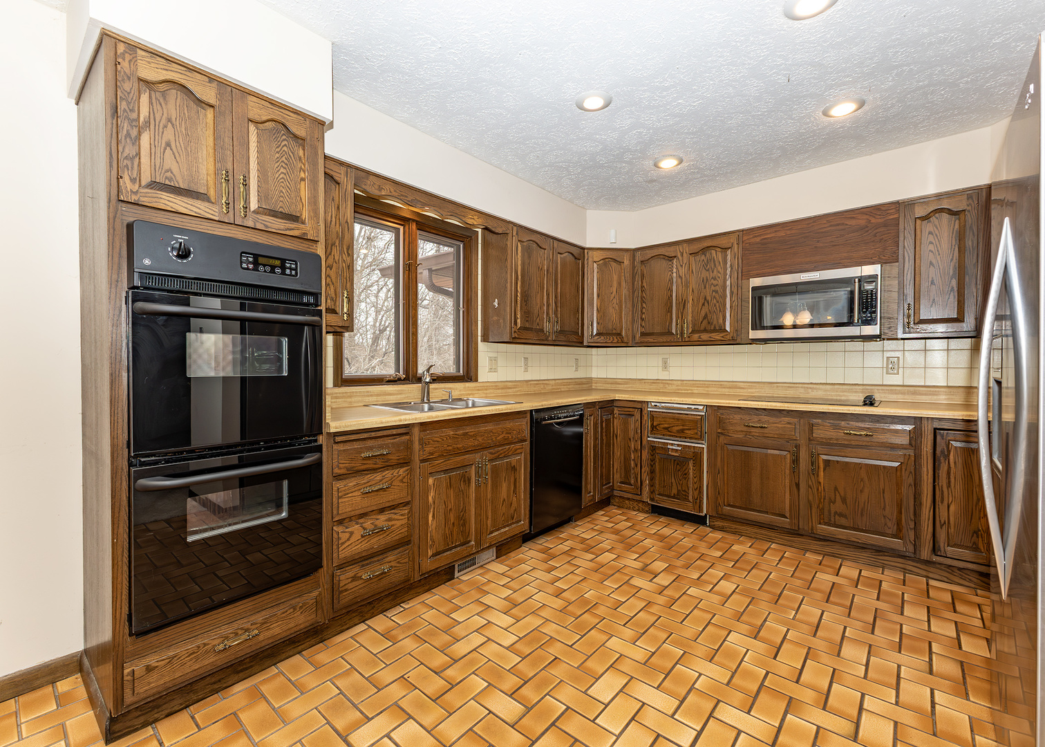 3748 53rd Street Moline, IL 61265 - Photo 12 of 24 a kitchen with stainless steel appliances granite countertop a refrigerator and a stove top oven