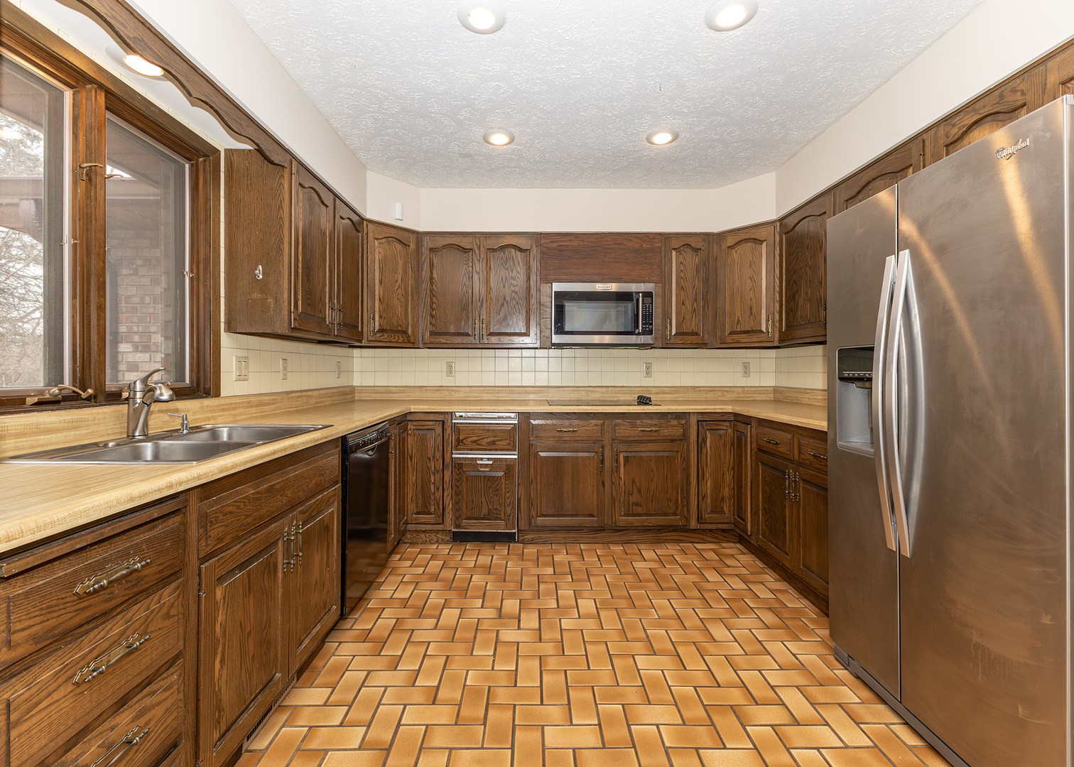 3748 53rd Street Moline, IL 61265 - Photo 13 of 24 a kitchen with a sink a counter top space stainless steel appliances and cabinets