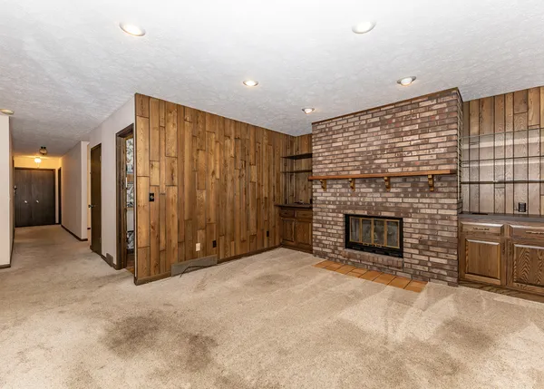 a view of an empty room with a fireplace
