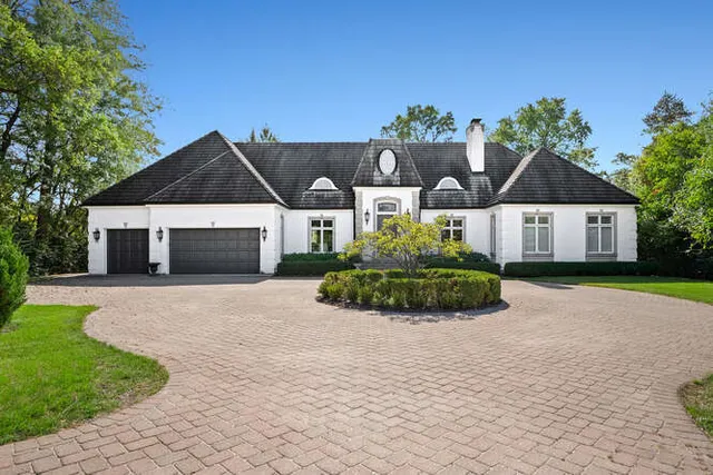 a front view of a house with a garden and yard
