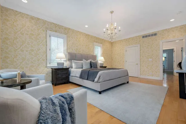 a spacious en suite bathroom with a double vanity sink and a bathtub