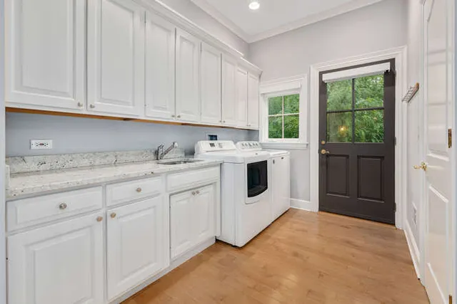 a spacious bedroom with a bed and a chandelier