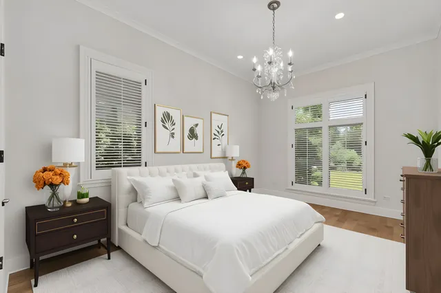 a bedroom with a bed and a chandelier