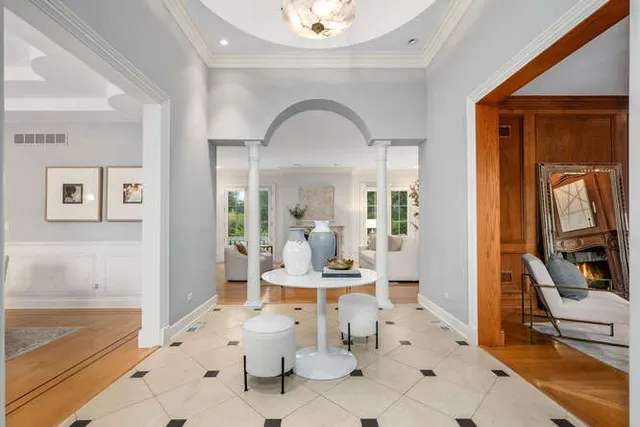 a view of a hallway with dining room and furniture