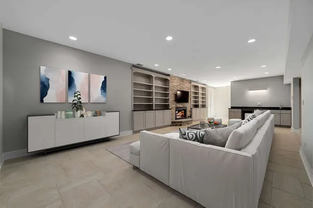 a view of an empty room with a fireplace and a projector