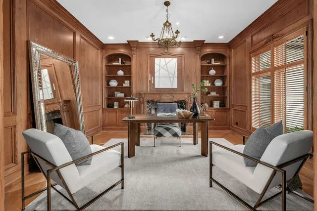 a living room with furniture a chandelier and a large window