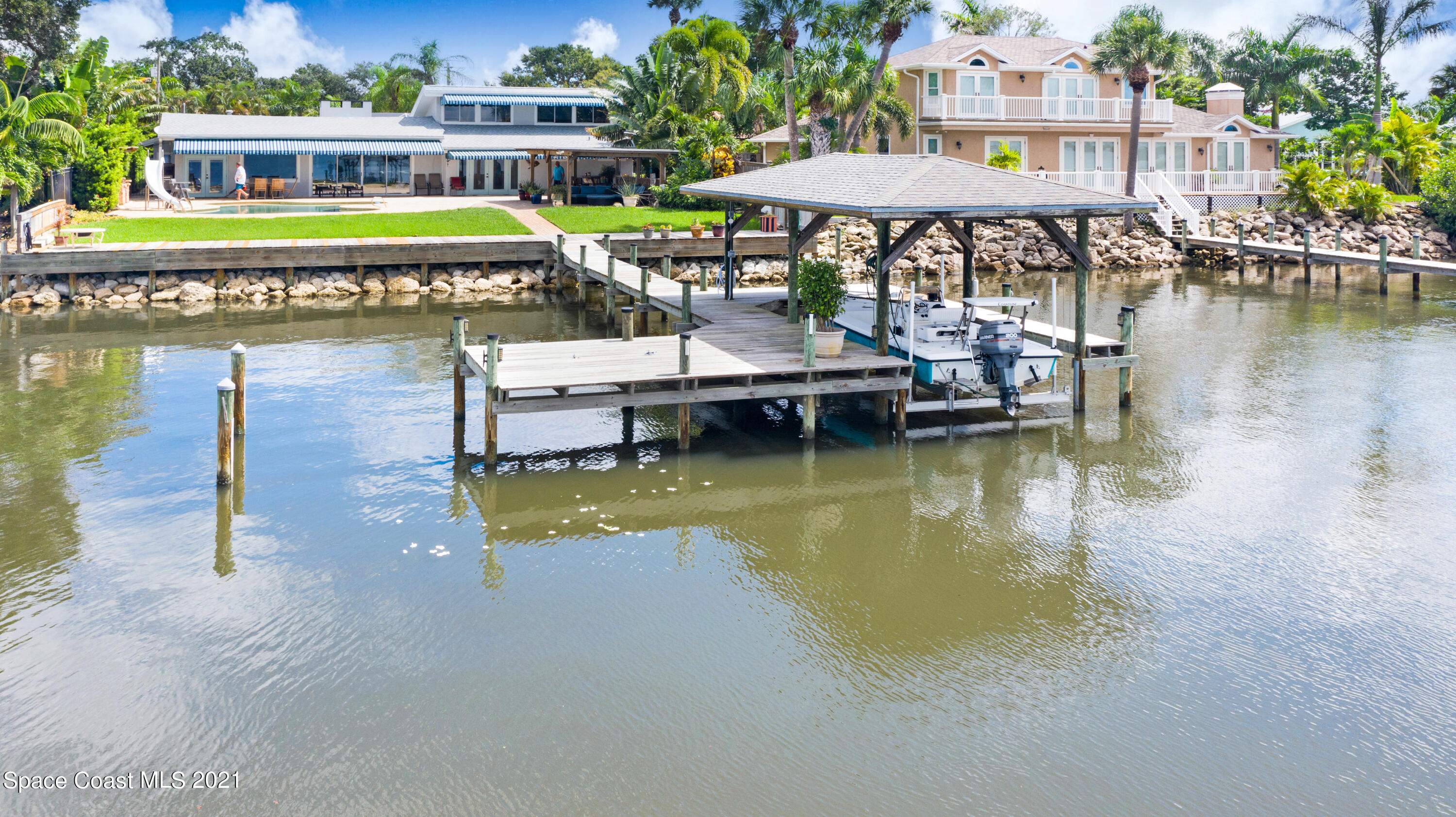 600 North Riverside Drive Indialantic, FL 32903 - Photo 16 of 85 a small pool with lawn chairs under an umbrella