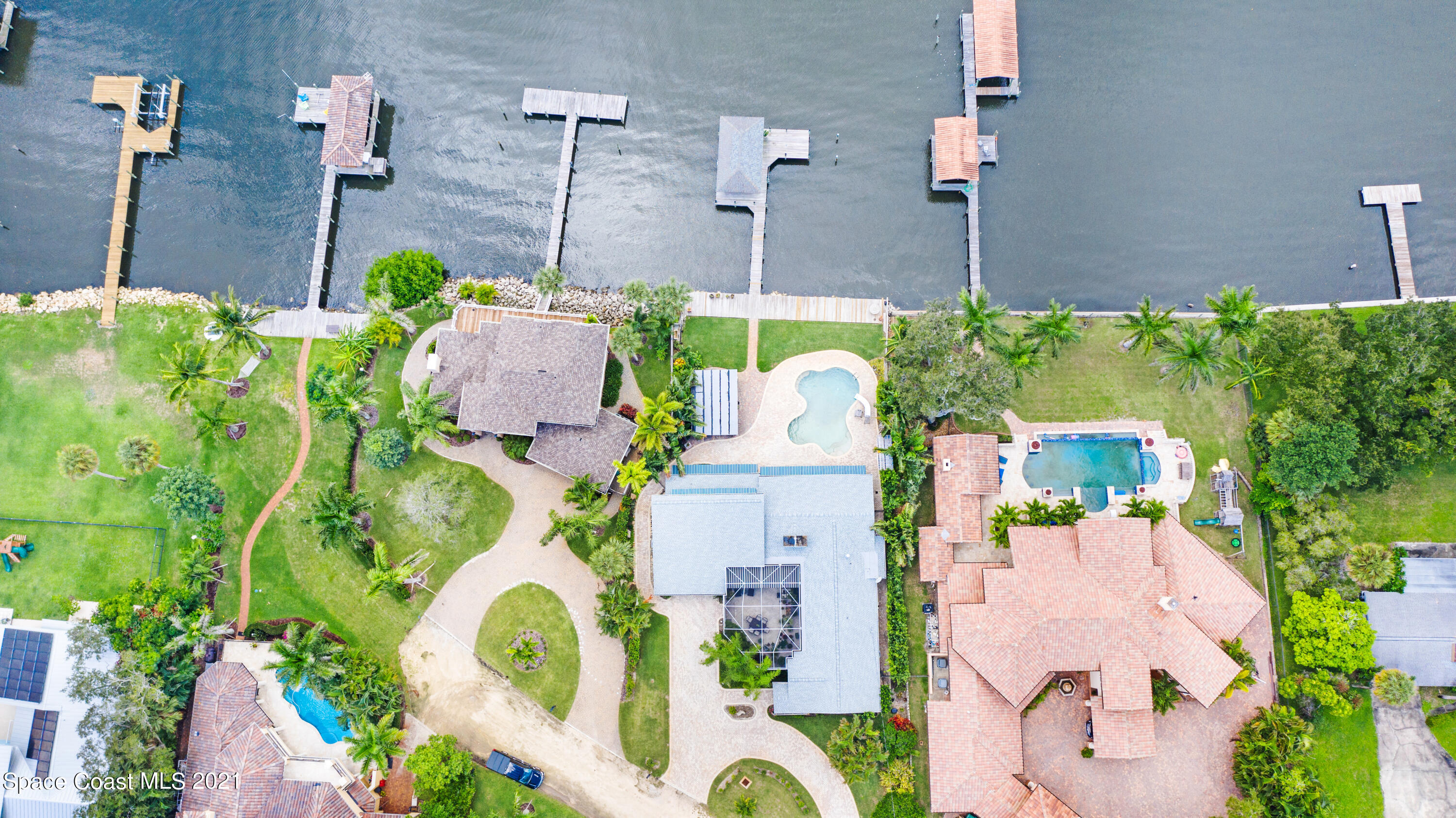 600 North Riverside Drive Indialantic, FL 32903 - Photo 20 of 85 an aerial view of a house with a yard and large trees
