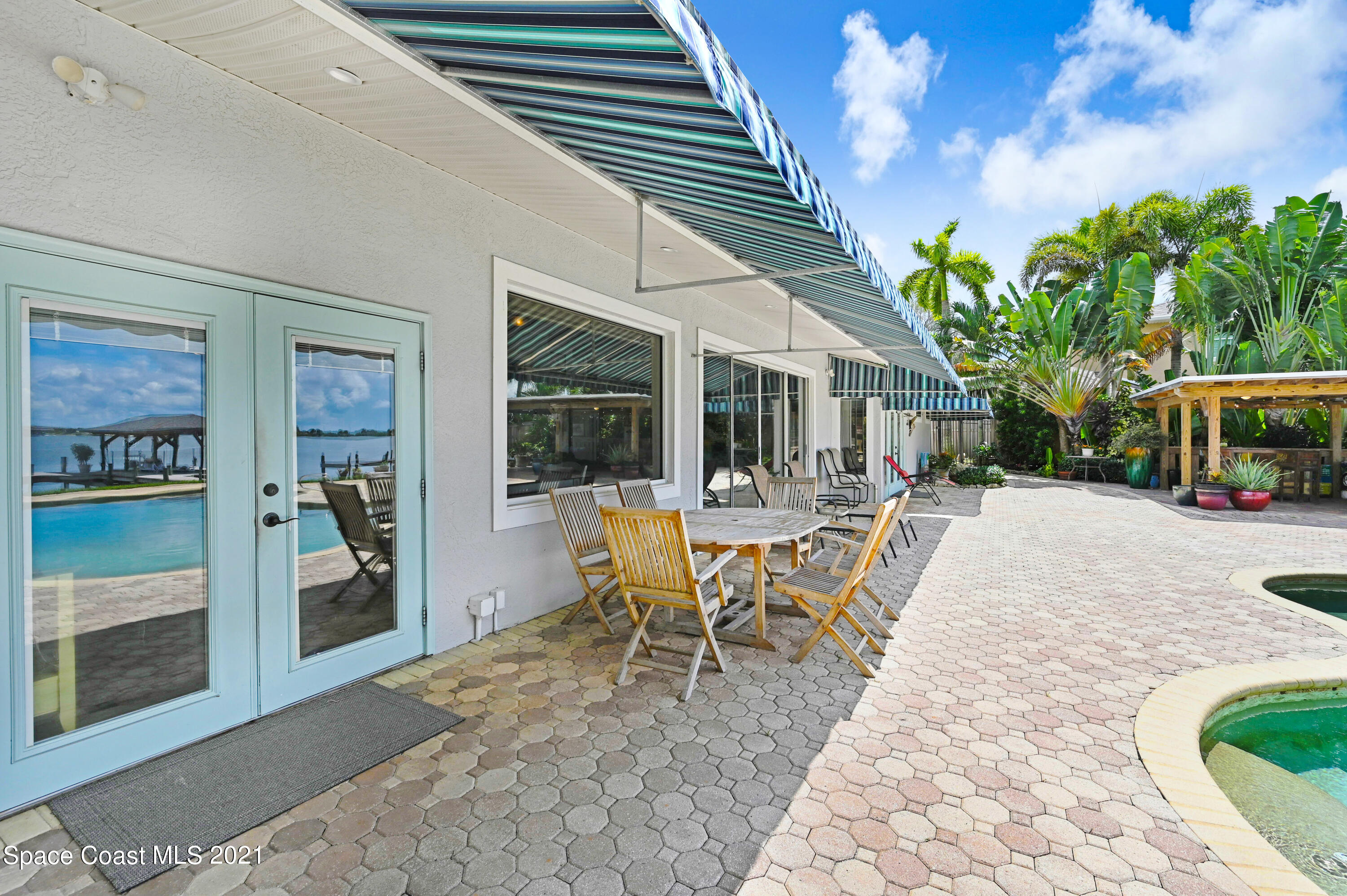 600 North Riverside Drive Indialantic, FL 32903 - Photo 23 of 85 a view of a patio with table and chairs and potted plants