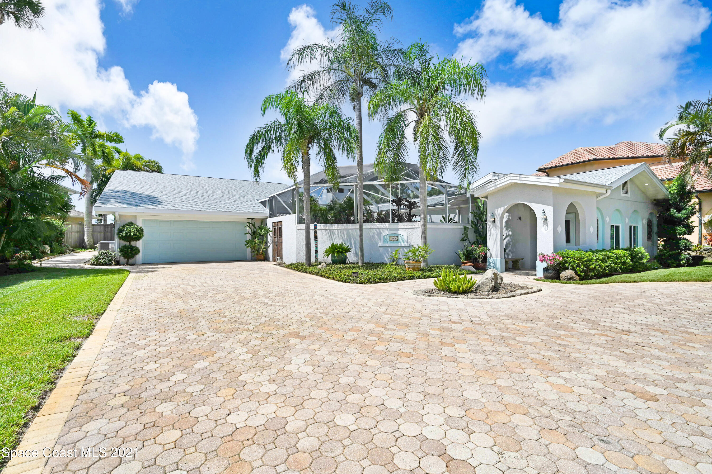 600 North Riverside Drive Indialantic, FL 32903 - Photo 39 of 85 a view of a house with a yard and palm trees