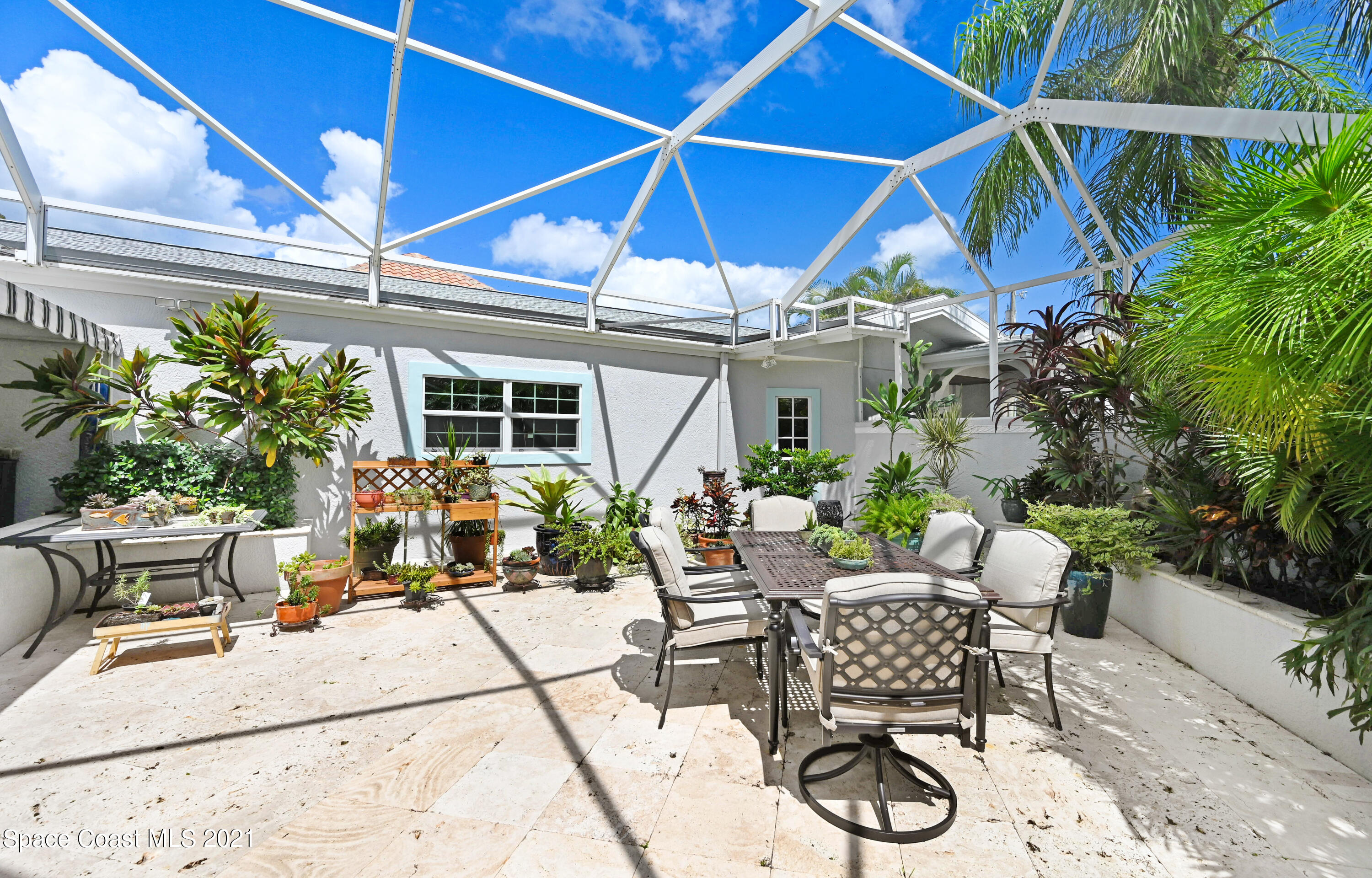 600 North Riverside Drive Indialantic, FL 32903 - Photo 40 of 85 a patio with a patio table and chairs
