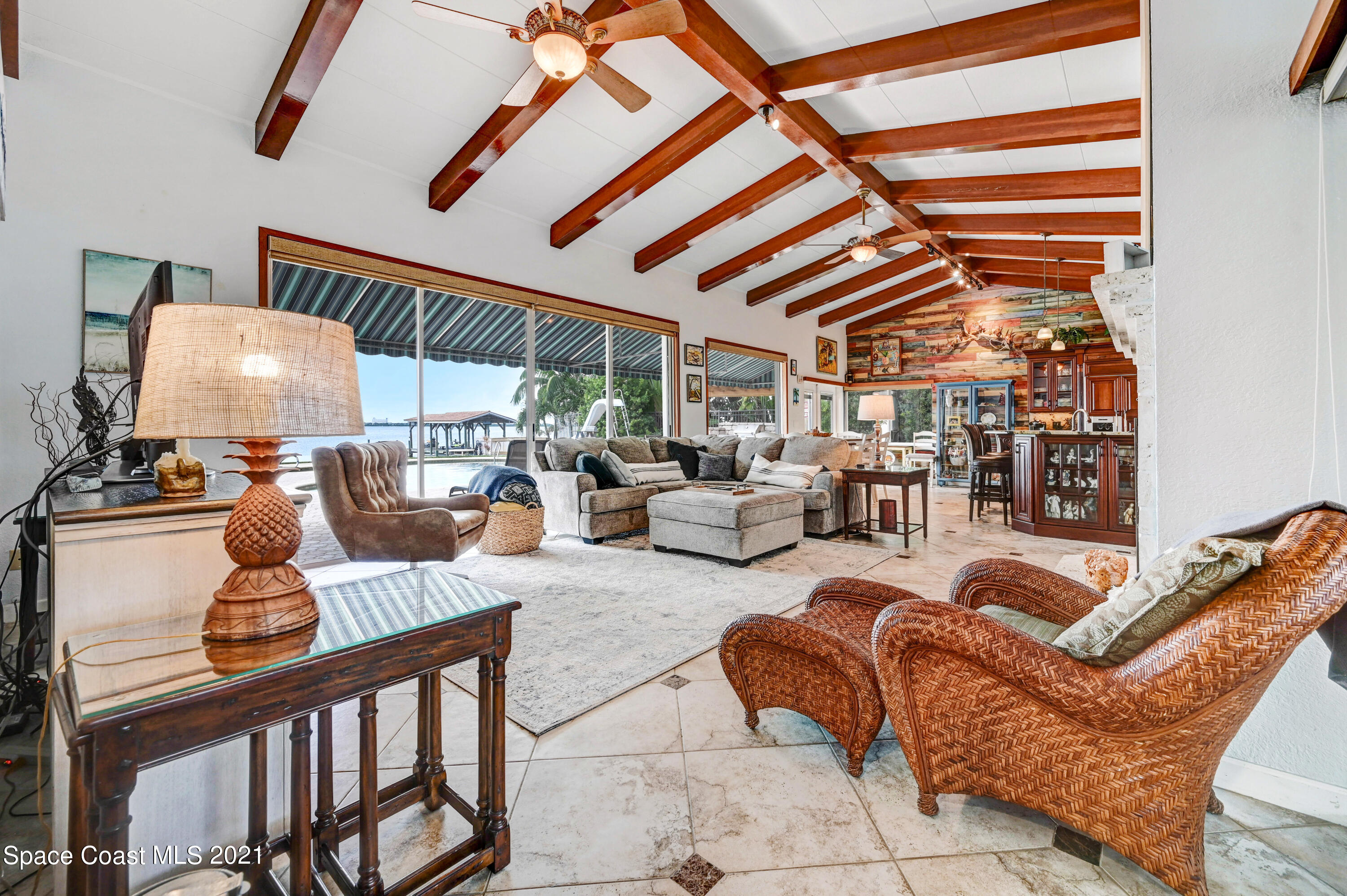 600 North Riverside Drive Indialantic, FL 32903 - Photo 45 of 85 a living room with furniture a ceiling fan and a window