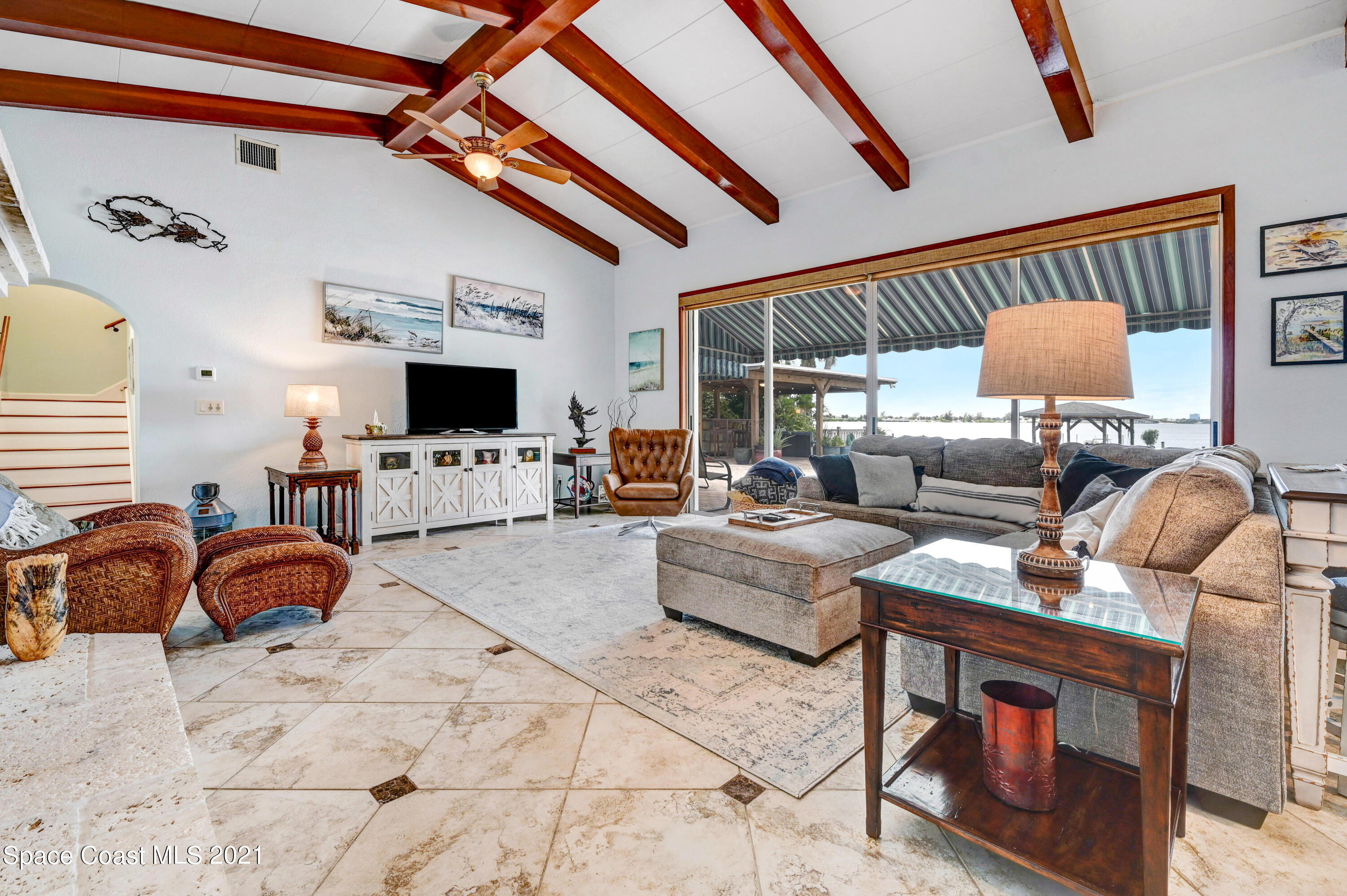 600 North Riverside Drive Indialantic, FL 32903 - Photo 46 of 85 a living room with furniture fireplace and flat screen tv