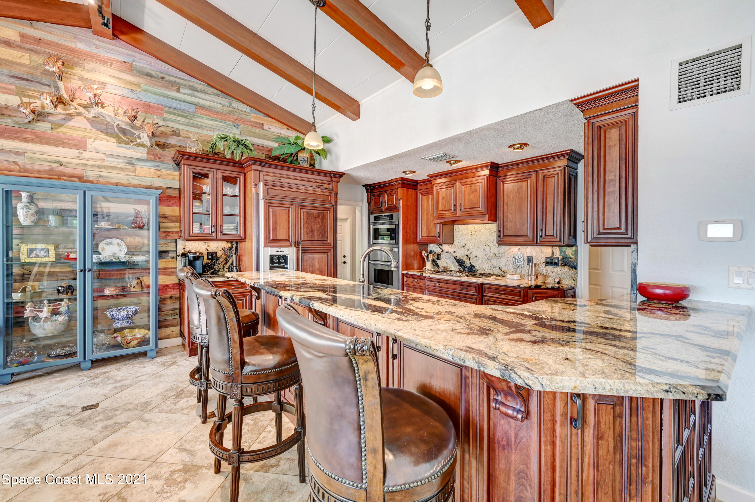 600 North Riverside Drive Indialantic, FL 32903 - Photo 53 of 85 a table room with a table chairs and a kitchen view