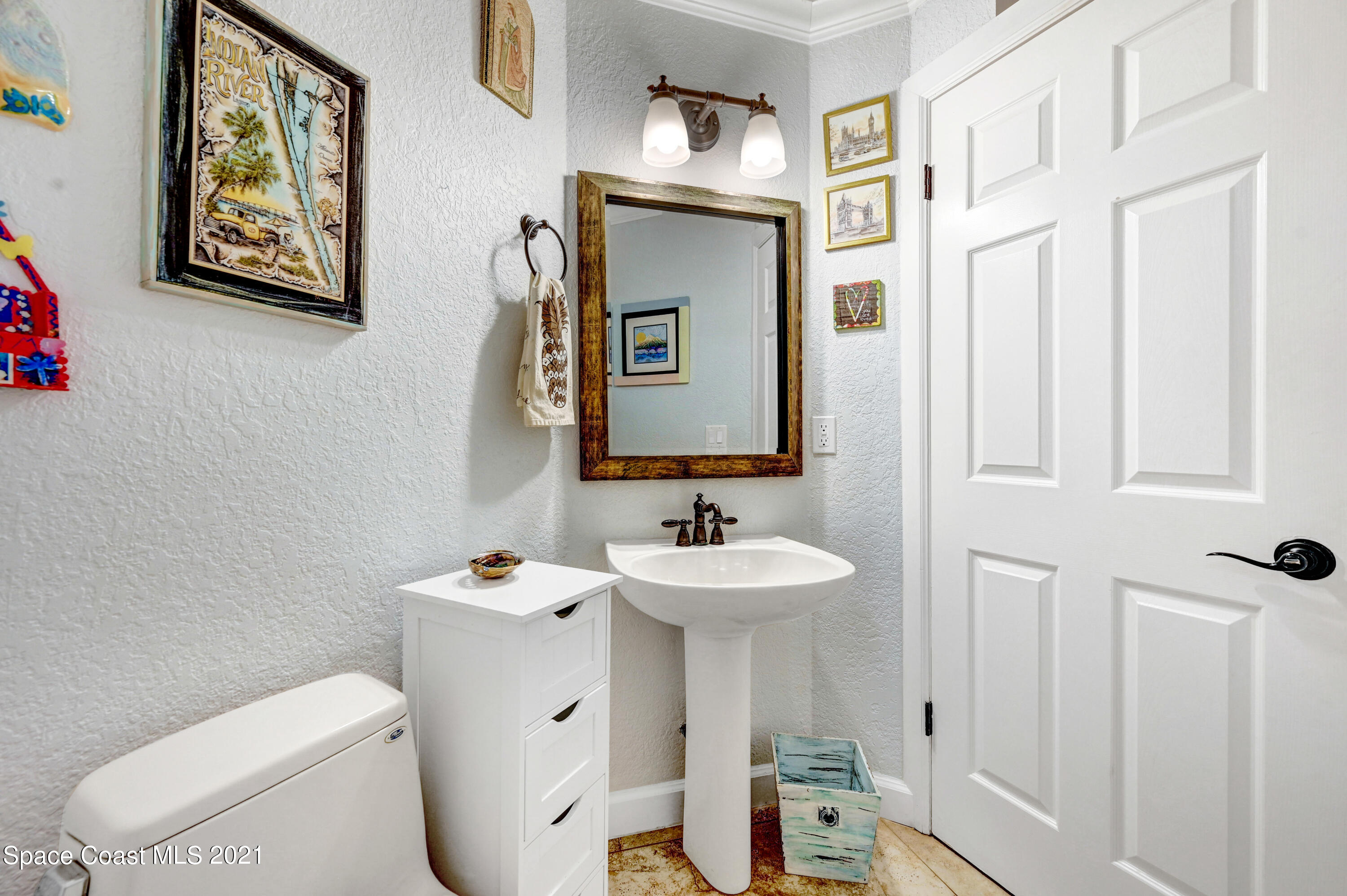 600 North Riverside Drive Indialantic, FL 32903 - Photo 58 of 85 a bathroom with a toilet sink and mirror