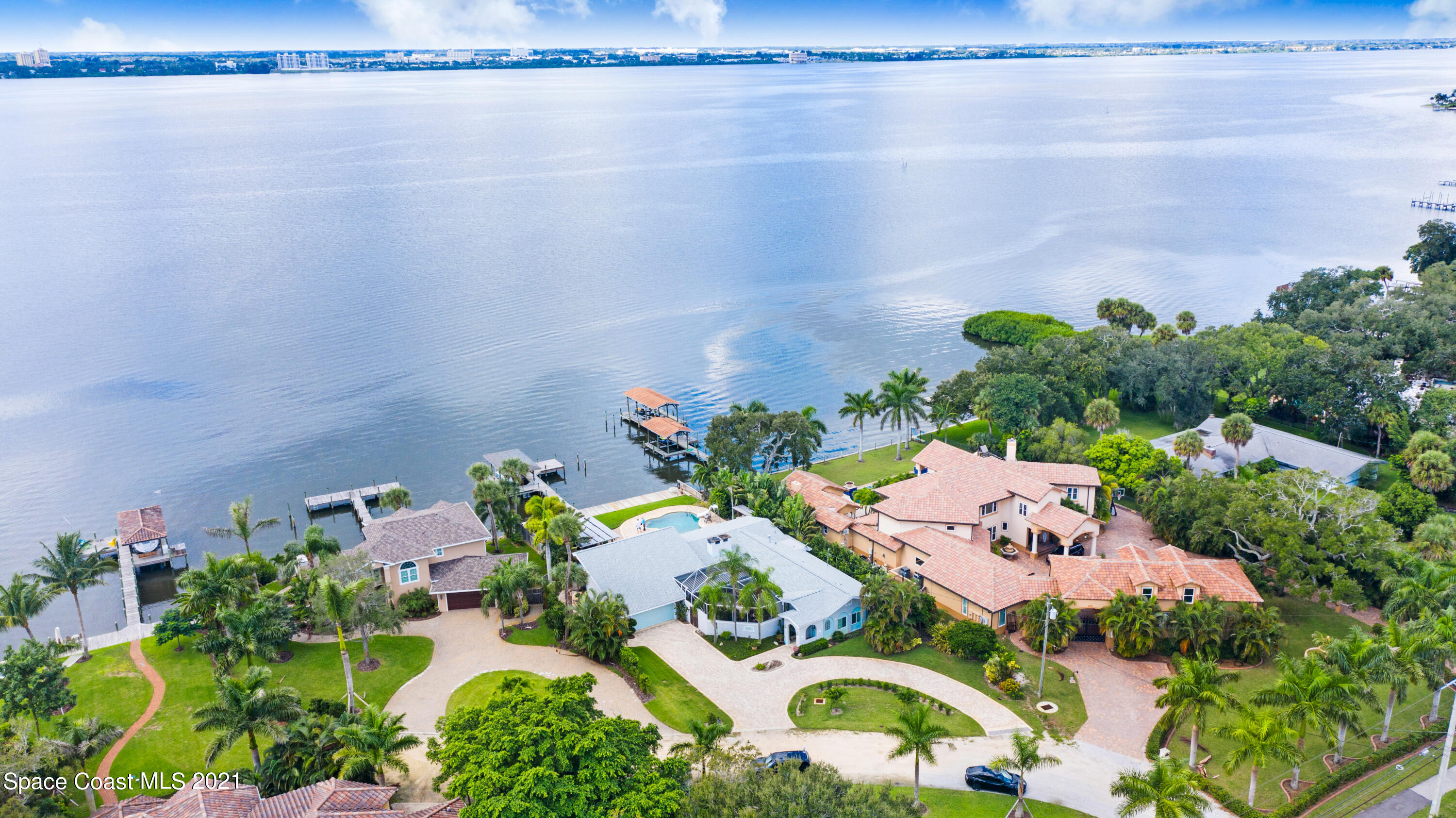 600 North Riverside Drive Indialantic, FL 32903 - Photo 8 of 85 an aerial view of a house with a yard and lake view